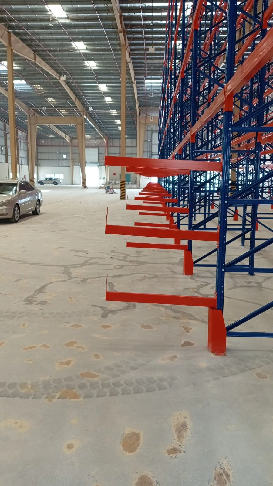 Cantilever warehouse racks with red steel arms installed by Metal Masters in a Dubai warehouse